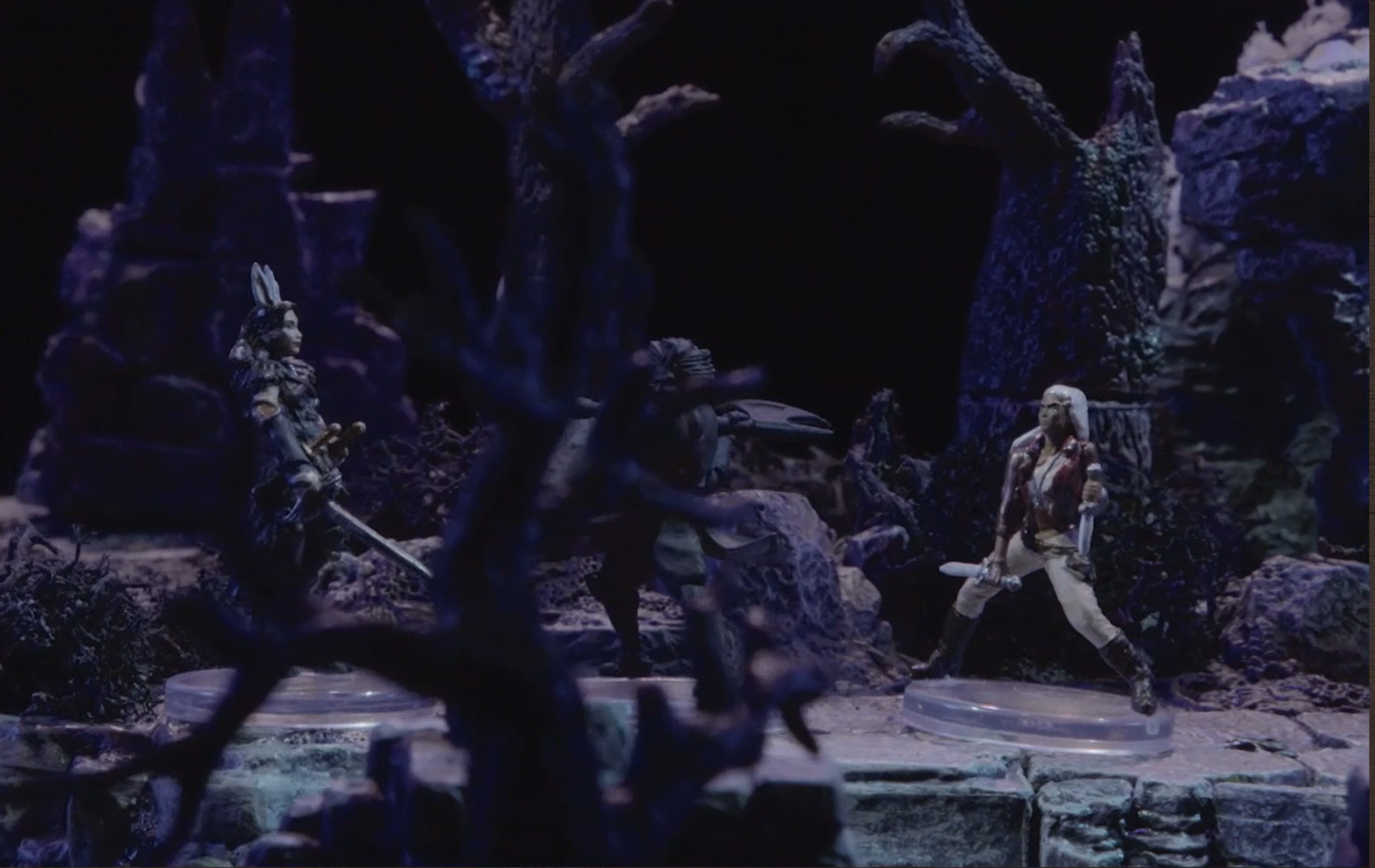 A view through some trees of a battlemap where Morrighan faces off a large shadowy Ted wielding an axe, and behind her Opal holding a dagger.