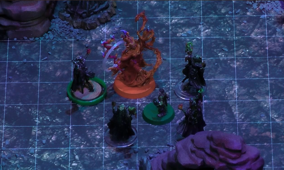 A battlemap where Orym and Fearne in her titan form face off against Dark Fearne and three clones of Dark Fearne. Fearne is wreathed in swirling, orange flames. Status condition rings are around Fearne and Dark Fearne.