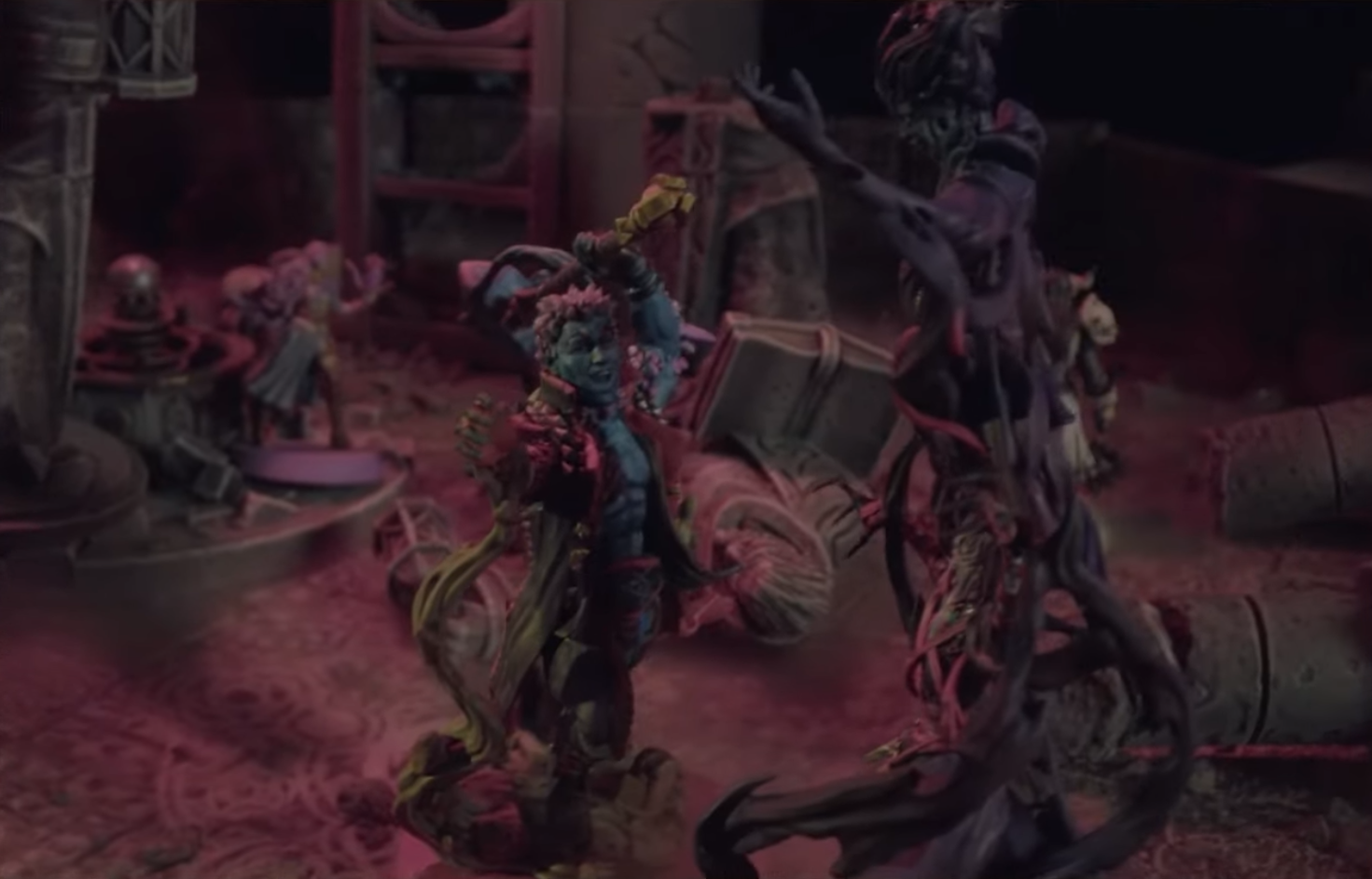 A miniature of Ashton in their titan form facing off against Laudna, the ghostly form of Delilah emerging from her, more than doubling her height. Ashon stands with his hammer raised behind his head, ready to strike.