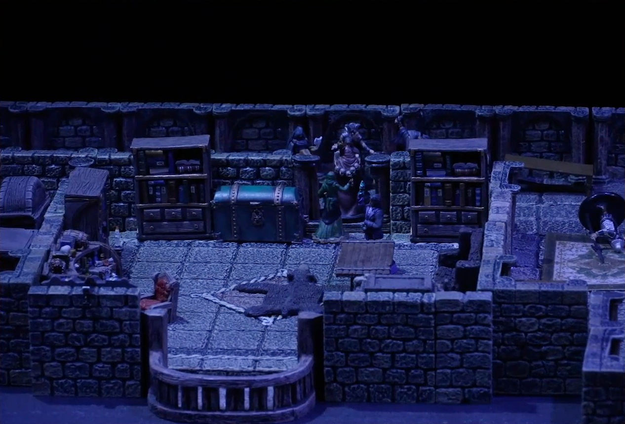 A battlemap of a stone palace upper floor. Occtis stands next to a wooden table in a room with a bearskin rug, balcony, cluttered desk, bench, and shelves. A number of robed individuals including Ethrand Tachonis stand outside the room, down the hall from a fallen guard. Aranessa stands in the room, facing the group of intruders.