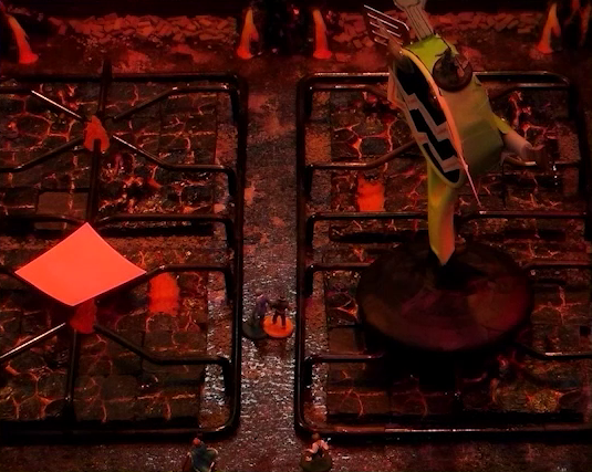 A battlemap that looks like a stovetop. Wok Wok, the giant frying pan creature, stands on the front right burner. Jessep and Kai stand between it and the front left burner, which has a pink sticky note on it. Small flames sprout from each burner. Beau stands on Wok Wok’s head and Yasha stands on its base. The base of the battlemap looks like magma and the scene is bathed in red light.