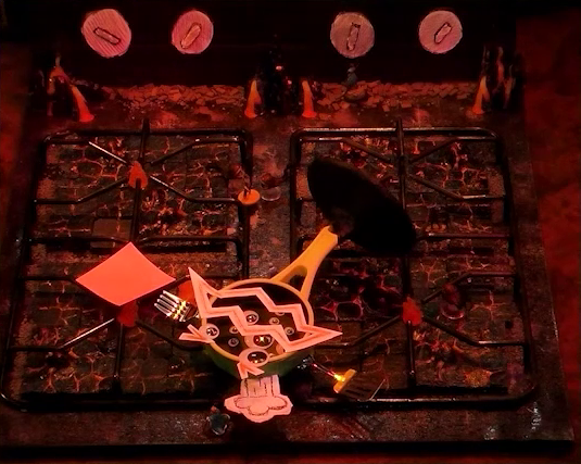 A battlemap that looks like a stovetop. Wok Wok, the giant frying pan creature, lies across the burners. Jessep, Kai, Sky, Padmund, Beau, and Yasha are spread across the rest of the stove. The front right burner has a pink sticky note on it. Small flames sprout from each of the four burners and four knobs are on the back panel. The base of the battlemap looks like magma and the scene is bathed in red light.