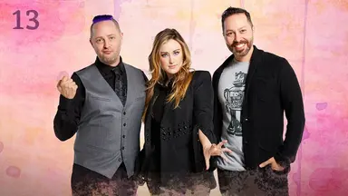 Thumbnail for episode 13. Taliesin, Ashley, and Sam pose together. Taliesin’s fist is raised at shoulder height as he makes a duck face. Ashley’s hand is out as if surreptitiously casting a spell. They are dressed in gray and black and stand against a colorful backdrop with splashes of reds, yellows, and purples.