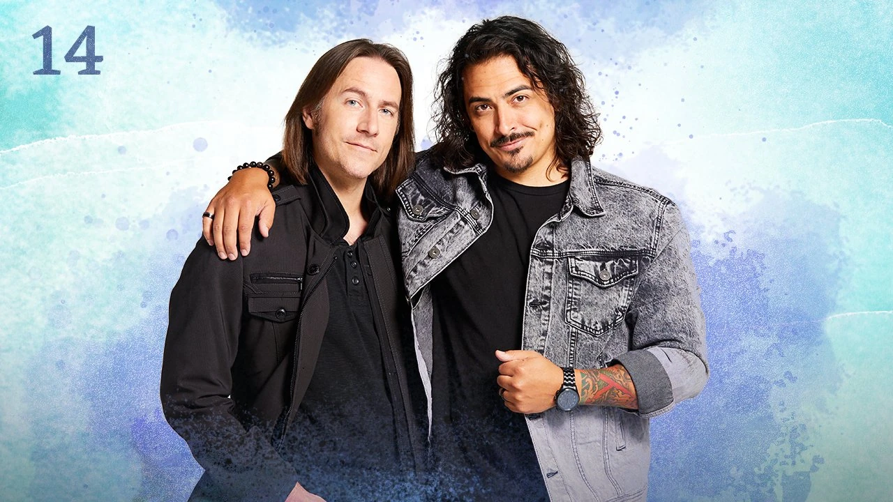 Thumbnail for episode 14. Matt and Robbie Daymond pose with their arms around each other’s shoulders. They are dressed in black and gray and stand against a colorful backdrop with splashes of blues and greens over white.