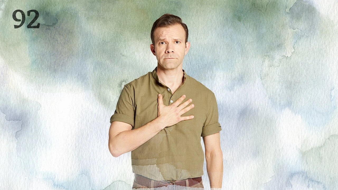 Thumbnail for episode 92. Liam stands sadly, his right hand placed against his chest. Hey is dressed in a green polo-style shirt with cuffed short sleeves tucked into brown pants with a brown leather belt. He stands against a colorful backdrop with watercolor splashes of greens and blues over white.