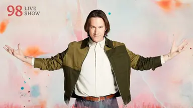 Thumbnail for the episode 98 live show. Matt stands dramatically with his arms raised palm up on either side of him. He is dressed in a brown leather jacket over a white shirt tucked into jeans. He stands against a colorful backdrop with splashes of oranges and blues over white.